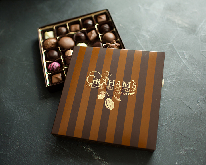 Graham's chocolate box with a selection of chocolates on a dark surface